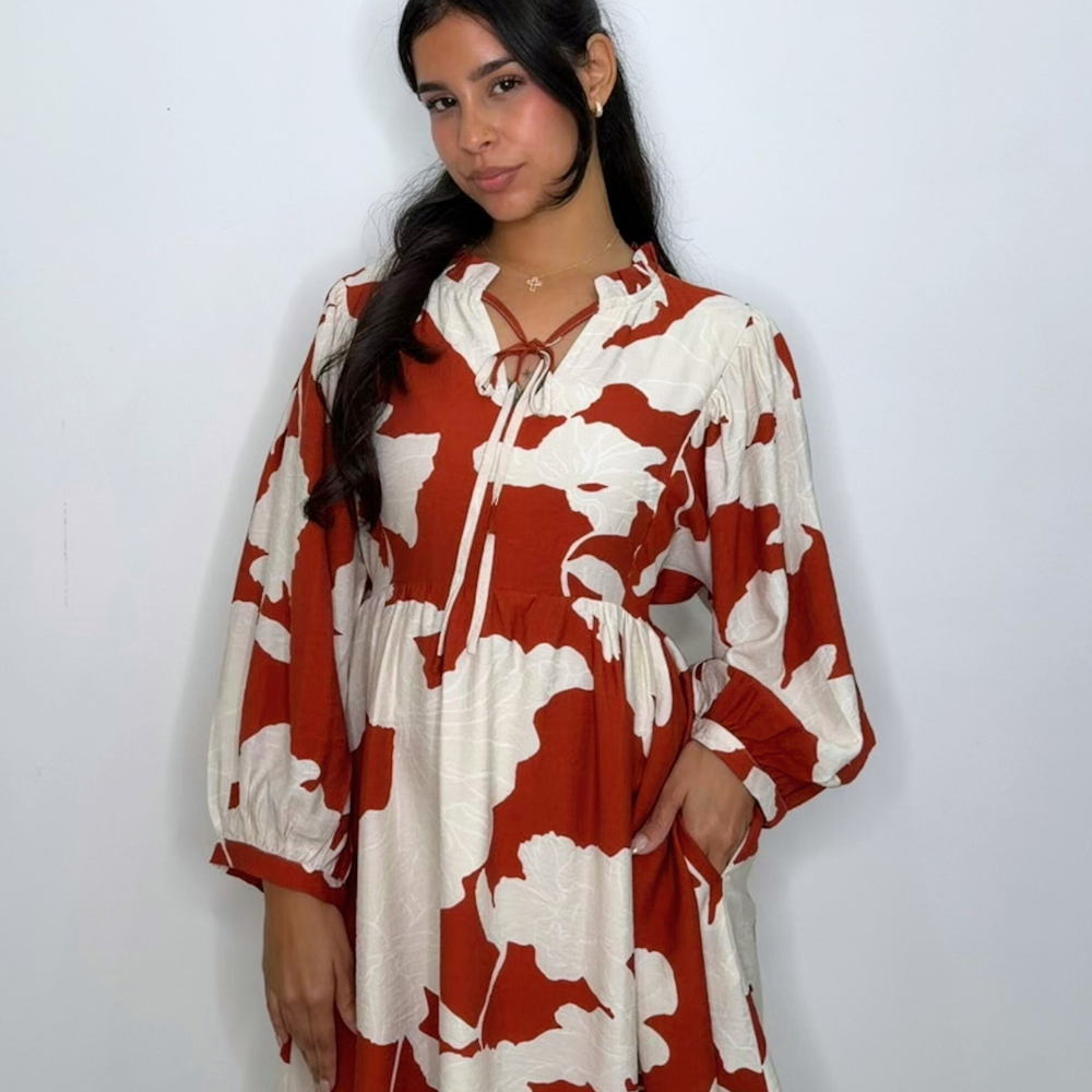 Loose fit peasant style floral dress, ruffled neckline detail, front tie, side pockets